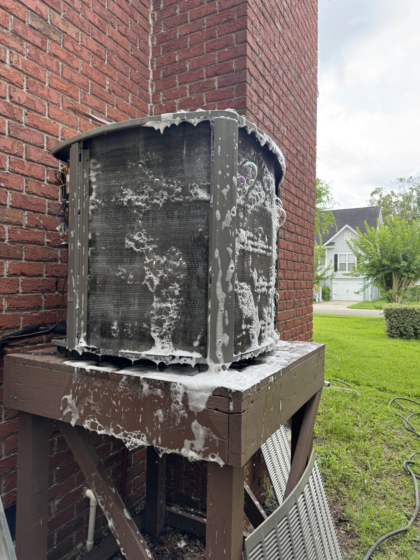 Maximum Air Experts technician performing AC repair and coil cleaning in North Charleston